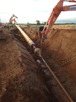 36 inch steel pipe being pulled into position ready for installation