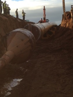 36 inch steel pipe being pulled into position ready for installation